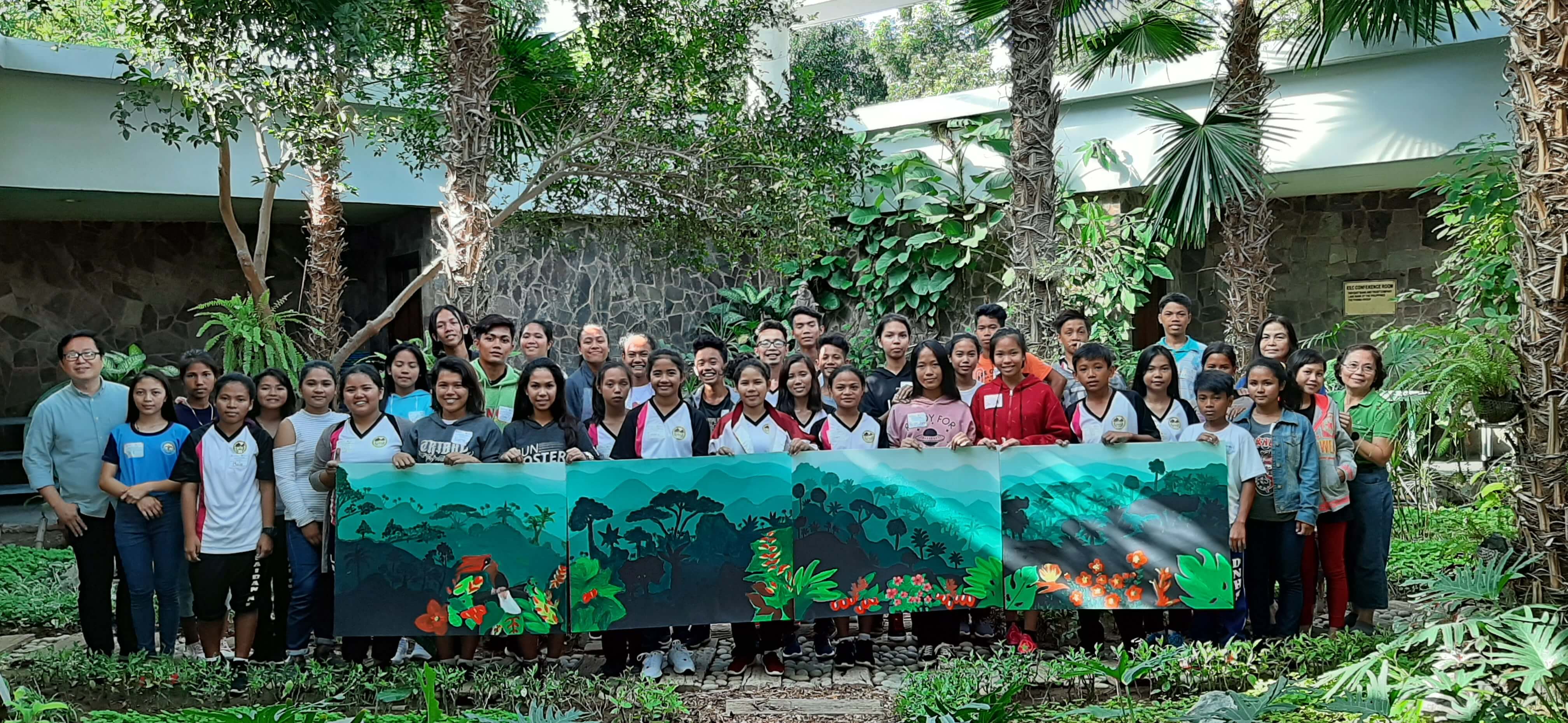 Youth from Brgy. Laiban with their paintings of forests